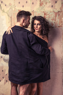 Sexy scene of woman and man in grunge interior