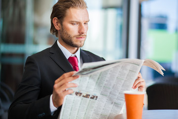     Handsome man with newspaper and coffee