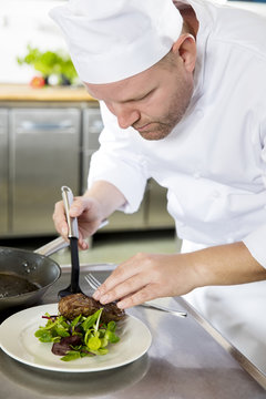 Professional chef prepare meat dish at restaurant