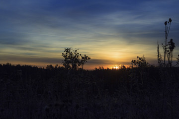 ruined house abandoned village on the background of the rising sun.