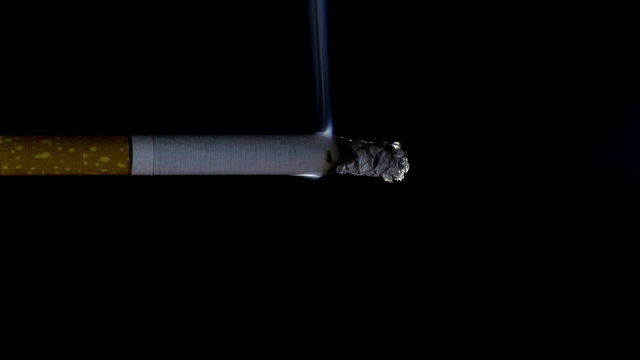 Cigarette on a black background, smoking