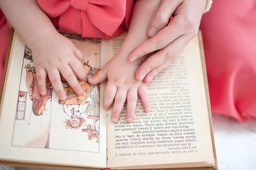 children's hands and picture book