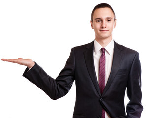 Businessman pointing to copy space, isolated on white background