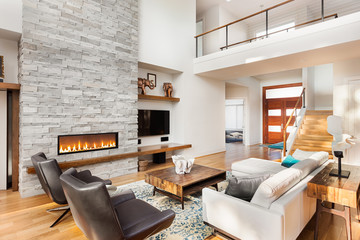 Beautiful living room interior with hardwood floors and fireplace in new luxury home