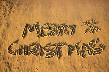 The inscription "Merry Christmas" on the sand.