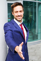 Young businessmen shaking hands