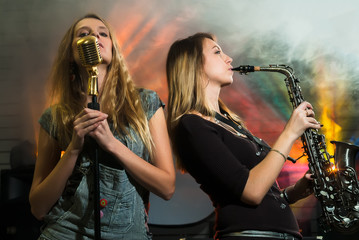 Young pretty women with saxophone