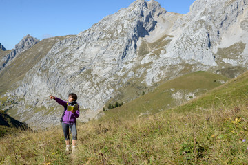 Naklejka na ściany i meble a woman hiker on a trail in the French Alps