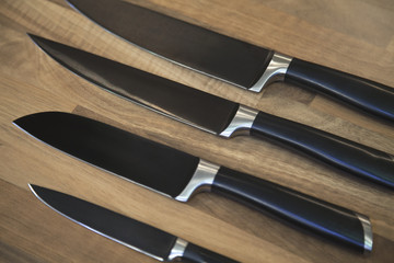 Set of kitchen knives on table.