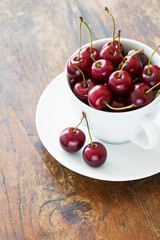 Fresh red cherries in a cup