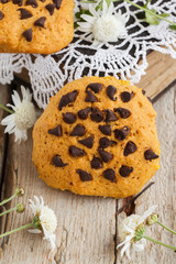 Cookies with chocolate on old books with fresh flowers.selective focus