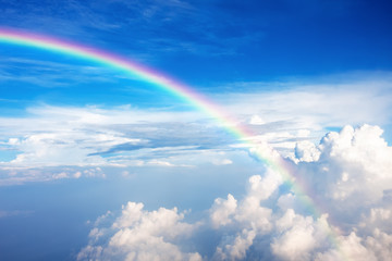Fototapeta na wymiar Blue sky with clouds and a rainbow