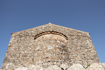Fototapeta na wymiar Stone byzantine building on blue sky with copy-space.