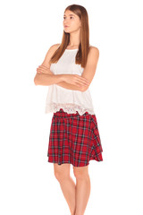 Pretty girl in a vest and skirt behind white wall