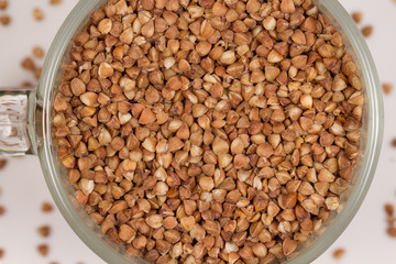Dry buckwheat in a glass mug