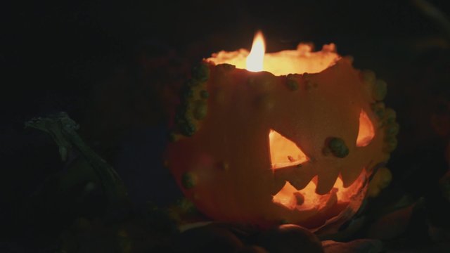 halloween slide shot of pumpkins with candle light at night