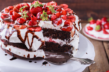 Chocolate cake with whipped cream and strawberries.selective focus