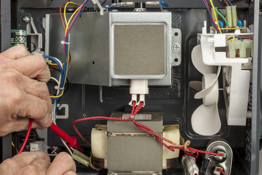 electrical engineer testing a microwave oven transformer