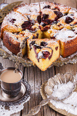 Plum cake with powdered sugar and a Cup of coffee.selective focus