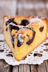 A piece of plum cake in powdered sugar