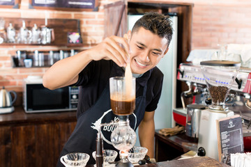 Barista preparing drip coffee in Asian coffee shop
