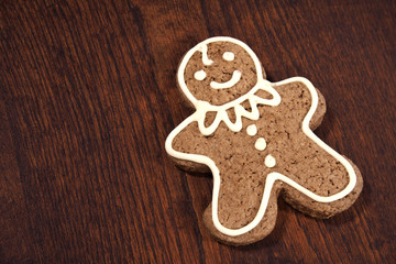 Gingerbread man - cookie, over a wooden table.
