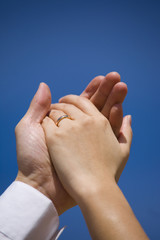 Couple holding hands with wedding ring