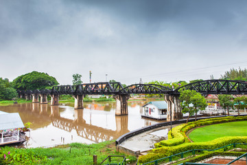 Fototapeta premium Railway Bridge in the rain cloud, River Kwai, Kanchanaburi, Thailand