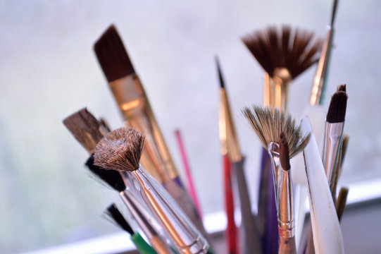 Closeup of colorful paintbrushes in an art studio