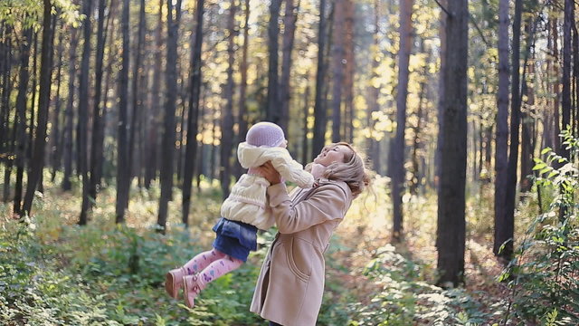 Mother and child walking in park