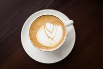 Hot art Latte Coffee in a cup on wooden table and Coffee shop bl