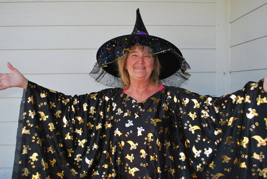 Mature female wearing her halloween costume outside.
