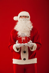 Photo of kind Santa Claus giving xmas present and looking at