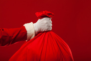 santa claus with big bag on shoulder glasses  red background