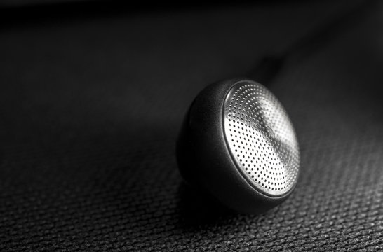 Black ear bud on black background, Selective focus and Close up detail image