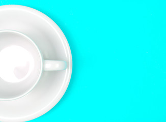 empty white coffee or tea cup on vibrant color background with t