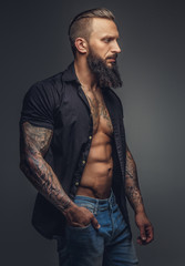 Fashionable tatooed man with beard.