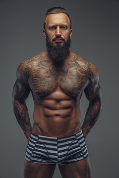 Fashinable mude tattooed man with beard.