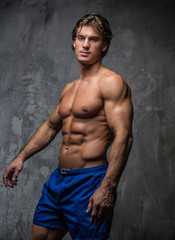 Obraz na płótnie Canvas Handsome muscular male in blue shorts.