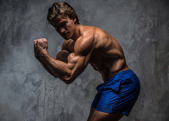 Fototapeta premium Strong muscular bodybuilder showing his body.