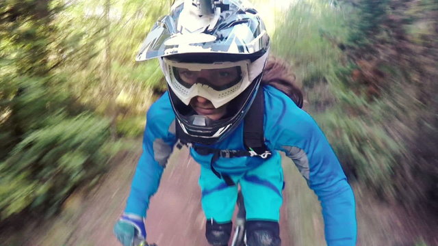 Biking as extreme and fun sport. Downhill Biking. Women in sport.