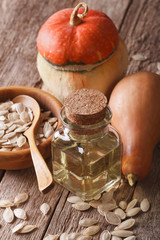 pumpkin seed oil in a bottle close-up on the table. vertical
