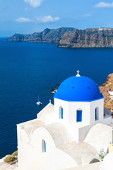 Fototapeta na wymiar Church with blue domes in Oia town, Santorini island, Greece