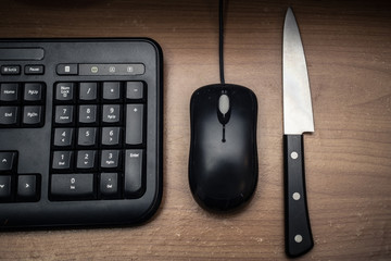knife with mouse in dark tone,computer online or social network killer murder concept