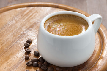 cup of coffee on a wooden tray, selective focus