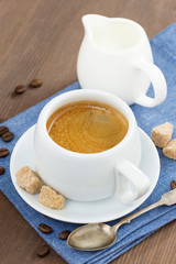 cup of espresso, sugar and jug of milk, vertical