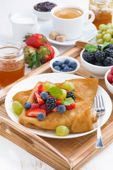 delicious breakfast - crepes with fresh berries and honey