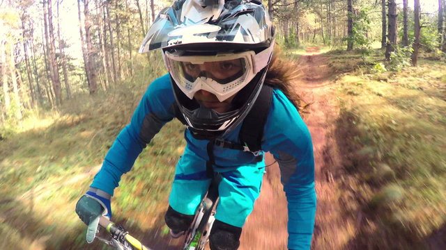 Biking as extreme and fun sport. Downhill Biking. Women in sport.