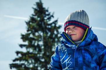 A child in winter clothes. Closeup
