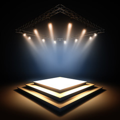 Empty stage illuminated by spotlights.
